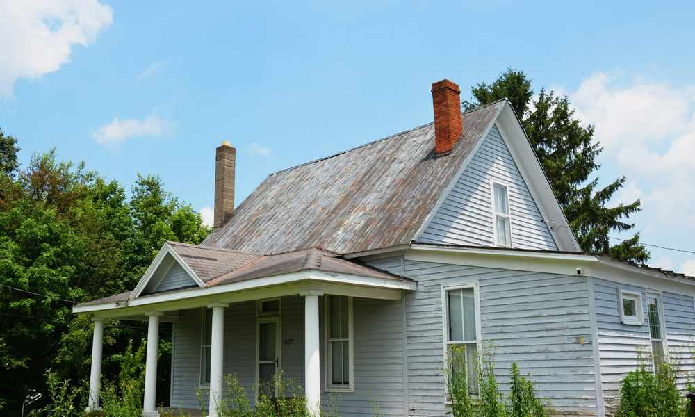 Wind-damaged siding panel on a home exterior